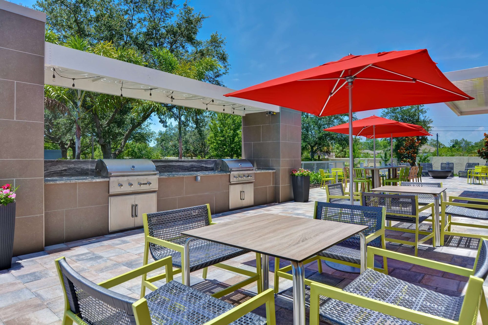 Outdoor patio with grills and umbrellas