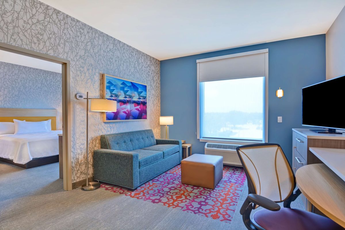 Suite living area with sofa bed and work desk